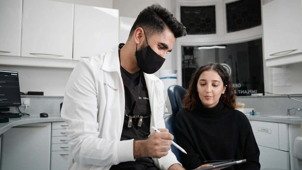 Emergency dentist reviewing a patient's dental pain symptoms